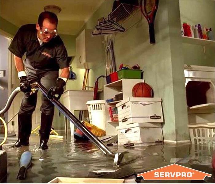flooded basement, worker extracting water
